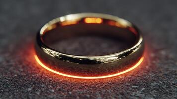 Intricate golden ring with glowing edge placed on textured surface during artistic display photo