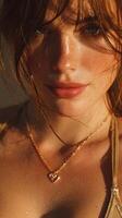 Close-up of a woman with glistening skin and heart necklace during golden hour in a natural setting photo