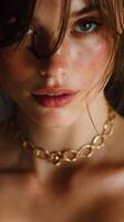 Close-up of a model showcasing a delicate gold chain necklace, highlighting naturally beautiful features in soft light photo