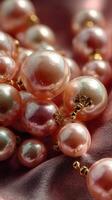 Beautiful collection of pink pearls resting on luxurious satin fabric in a soft, warm light during a serene afternoon photo