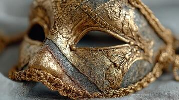 Elegant gold and silver decorative mask displayed on soft fabric background at a cultural celebration photo