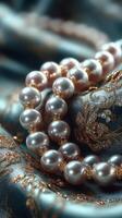 Elegant pearl necklace resting on luxurious blue fabric with gold accents, showcasing intricate details and textures photo