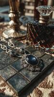 Elegant vintage jewelry and glass decanter displayed on a richly textured surface in a softly lit setting photo