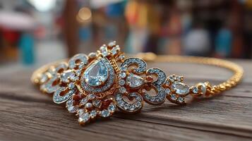 Elaborate golden bracelet adorned with sparkling stones showcased on wooden surface photo