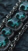 Shimmering teal gemstones set in silver jewelry displayed on a dark textured background photo
