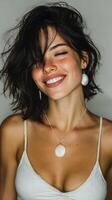 Young woman smiling with seashell jewelry in a casual portrait taken in a neutral setting photo