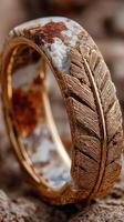 Intricately designed ring featuring natural stone and metallic elements displayed on textured background photo