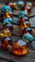 Colorful amber and turquoise beads arranged beautifully on weathered wooden surface photo