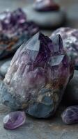 Beautiful amethyst crystal cluster on gray stones in natural light showcasing rich purple hues in a serene setting photo