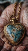 Vintage heart-shaped locket with floral design held in weathered hands showcasing intricate details and sentimental value photo