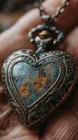Antique heart-shaped locket with intricate details resting in a hand, showcasing its worn beauty and history photo