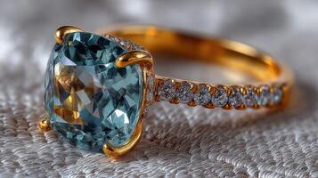 Elegant gold ring featuring a large aquamarine gemstone and diamond accents on a textured surface photo