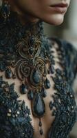 Elegant black lace gown adorned with intricate jewelry featuring dark gemstones, showcasing exquisite craftsmanship photo