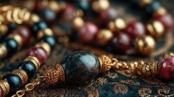 Elegant handcrafted jewelry featuring colorful stones and intricate gold embellishments displayed on ornate fabric photo