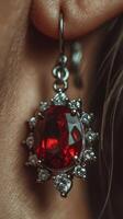 Elegant red gemstone earring showcasing intricate details and brilliance in close-up view photo