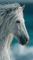 Majestic white horse gazes towards the sea under a clear blue sky in a serene coastal landscape photo