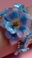 Blue flower accessory showcases intricate design with shimmering details against a soft background photo