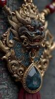 Intricate dragon ornament with blue and gold detailing displayed against textured background photo