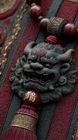 Intricate carving of a guardian lion ornament with red and gold accents displayed on a textured background photo