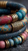 Colorful beaded bracelets with intricate designs displayed on textured surface photo