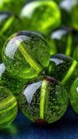 Bright green glass marbles clustered together on a smooth surface in a soft, diffused light environment photo