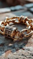 Golden chain bracelet resting on a textured surface under natural light during the afternoon in an outdoor setting photo