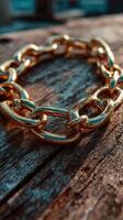 Close-up view of a beautifully crafted gold chain resting on an aged wooden surface in natural light photo
