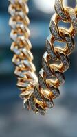 Shiny gold chain necklace featuring diamond accents in a close-up view highlighting its intricate design photo