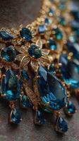 Exquisite jewelry featuring blue gemstones and intricate gold detailing showcased against a dark background photo