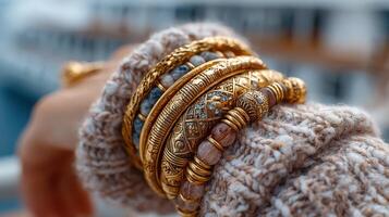 Beautiful collection of golden bangles worn on a cozy knitted sweater during a casual outdoor gathering photo