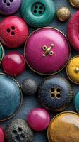 Colorful collection of buttons displayed on a textured surface showcasing various shapes and sizes photo