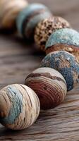 Natural wood beads with textures and colors arranged on a wooden surface highlighting craftsmanship photo