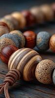 Handcrafted wooden beads arranged on a rustic wooden surface showcasing intricate textures and natural colors photo