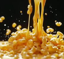 A large amount of macaroni is covered in a yellow sauce photo
