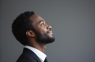 A man in a suit and tie is looking up at the sky photo