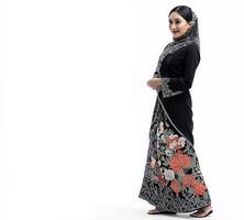The dress is long and flowing, and the woman is smiling photo