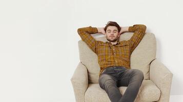 A man is sitting in a chair and appears to be relaxed photo