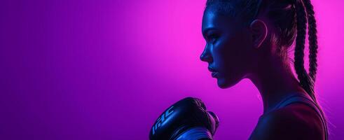 A strong woman wearing a boxing glove is standing in front of a purple background photo