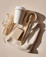 A bag with a cup, toothbrush and a paper towel photo
