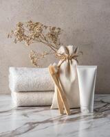 Towels, toothbrush and toothpaste on a marble counter photo