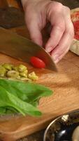 Vertical . Making pizza. Hands cutting ingredients for pizza. video