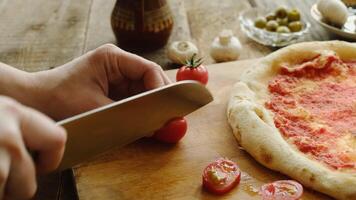 Making pizza. Hands cutting ingredients for pizza. video