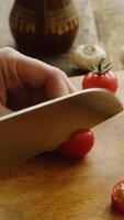 Vertical . Slicing tomatoes on chopping board video