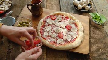 Making pizza. Woman cooks homemade pizza with tomatoes and mushrooms on dough video