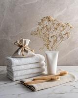 Towels, toothbrush and bag of herbs on a marble counter photo
