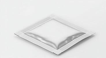 A white square packet of medicine on a white surface photo