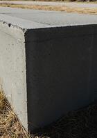 A concrete block sitting in the grass photo