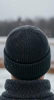 A man wearing a beanie in the snow photo