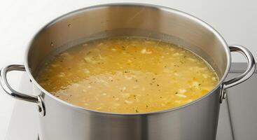 A pot of soup on a stove top photo