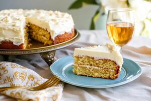 A cake with frosting on a plate and a glass of wine photo